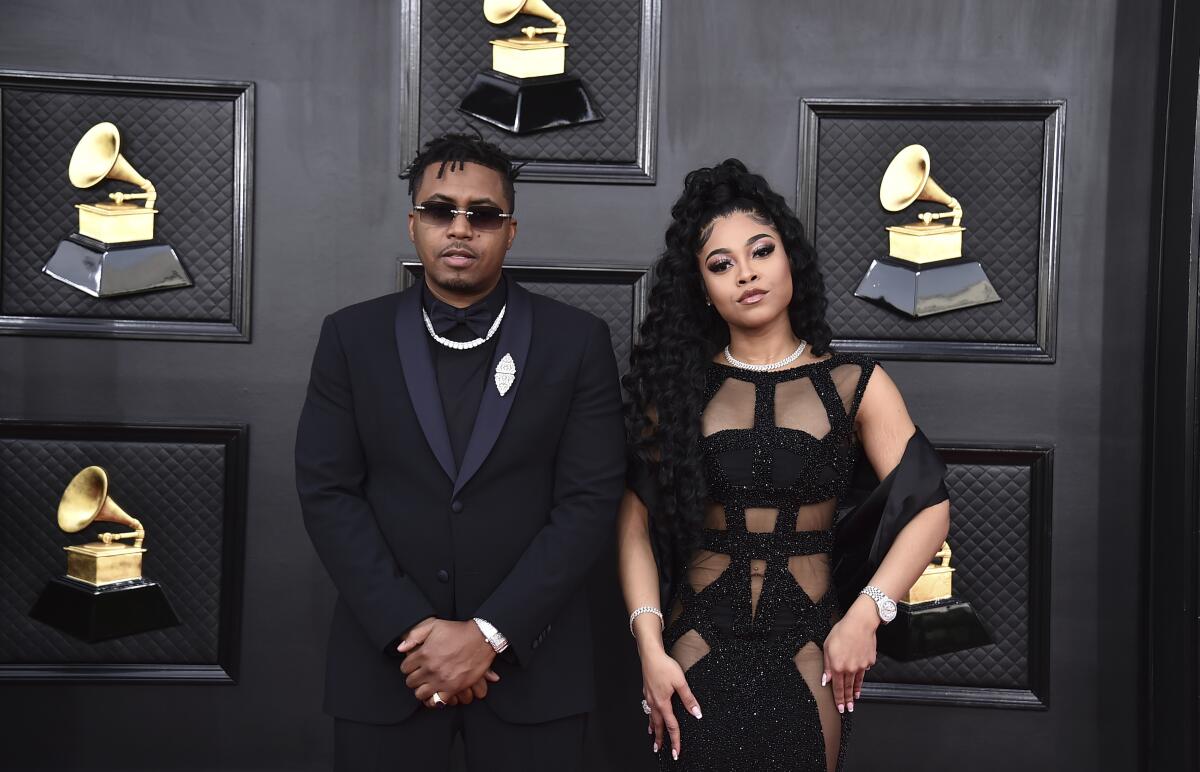 Nas, left, and Destiny Jones arrive at the 64th Grammy Awards.