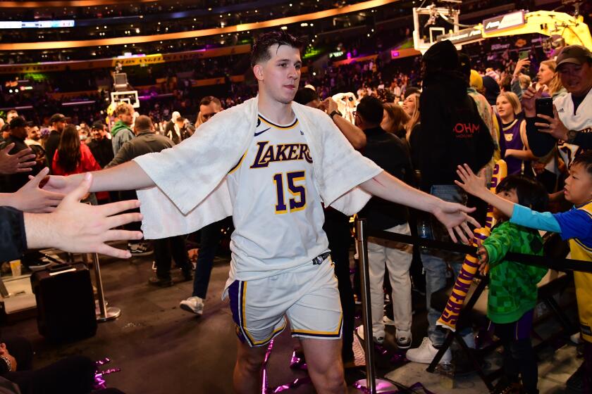 LOS ANGELES, CA - MARCH 19: Austin Reaves #15 of the Los Angeles Lakers walks off the court.