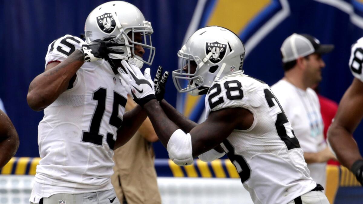 Raiders wide receiver Michael Crabtree (15) celebrates his touchdown with teammate Latavius Murray in the second half of a win over the Chargers on Sunday in San Diego.