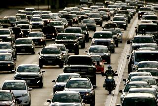 LONG BEACH, CALIF. - SEPT. 1, 2022. Traffic streams down the San Diego Freeway in Long Beach as people make the Labor Day weekend getaway on a warm Friday afternoon, Sept. 2, 2022. (Luis Sinco /. Los Angeles Times)