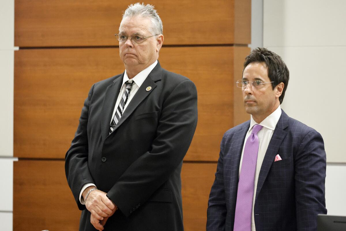 Scot Peterson and defense attorney Mark Eiglarsh stand as the jury enters the courtroom 