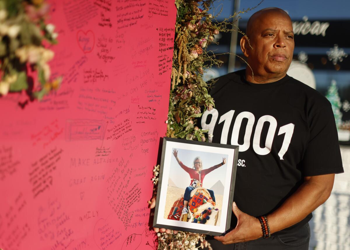 David Swayne holds a photo of his late sister, Lora Swayne.