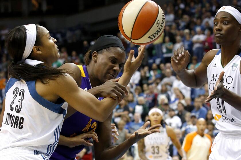Lynx forward Maya Moore (23) knocks a rebound away from Sparks center Jantel Lavender during the first half of their WNBA playoff opener on Friday night in Minneapolis.