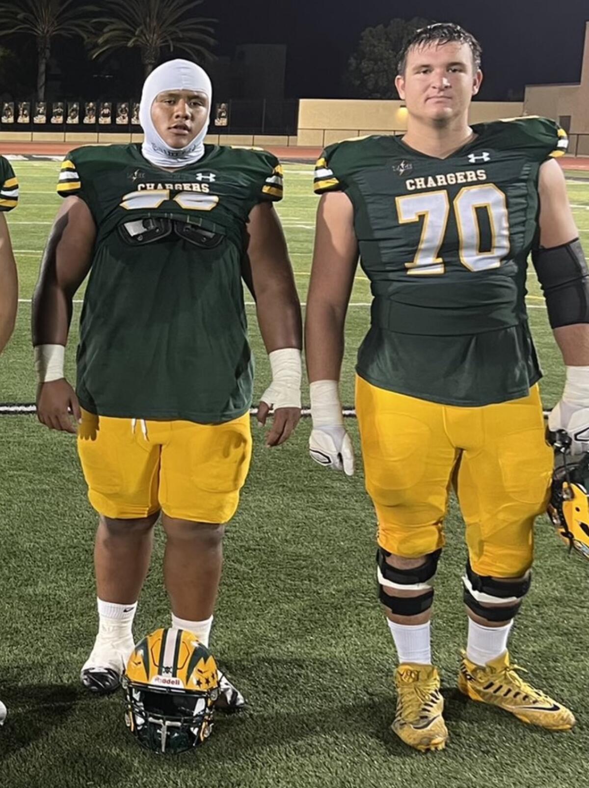 Edison linemen Makai Sagiao, left, and Nathan Gates.