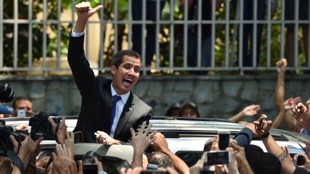 Venezuelan opposition leader Juan Guaido gives the thumb up to supporters after a March 27 rally in Caracas.