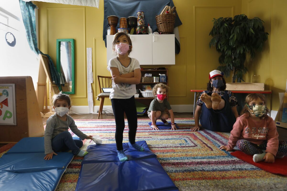 Kirsten Hove, second from right, does stretching exercises with children.