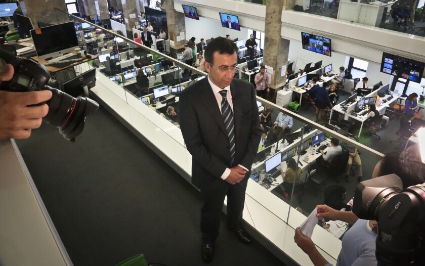 Ehab Al Shihabi, interim CEO for Al-Jazeera America, listens during an interview overlooking the newsroom, after the network's first broadcast on Tuesday, Aug. 20, 2013 in New York.