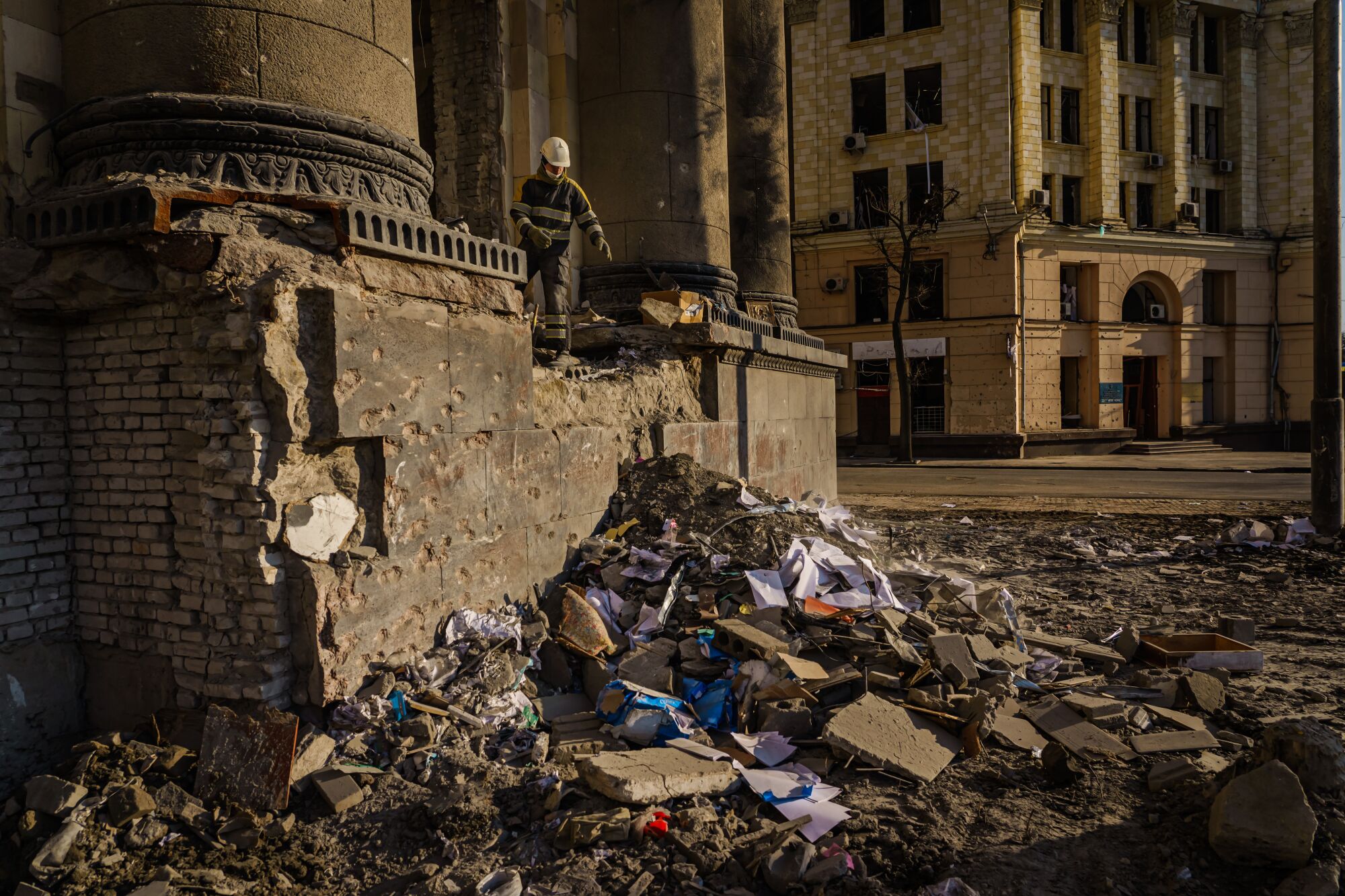 Firefighters clean up debris inside the Kharkiv Regional Administration building after it was destroyed