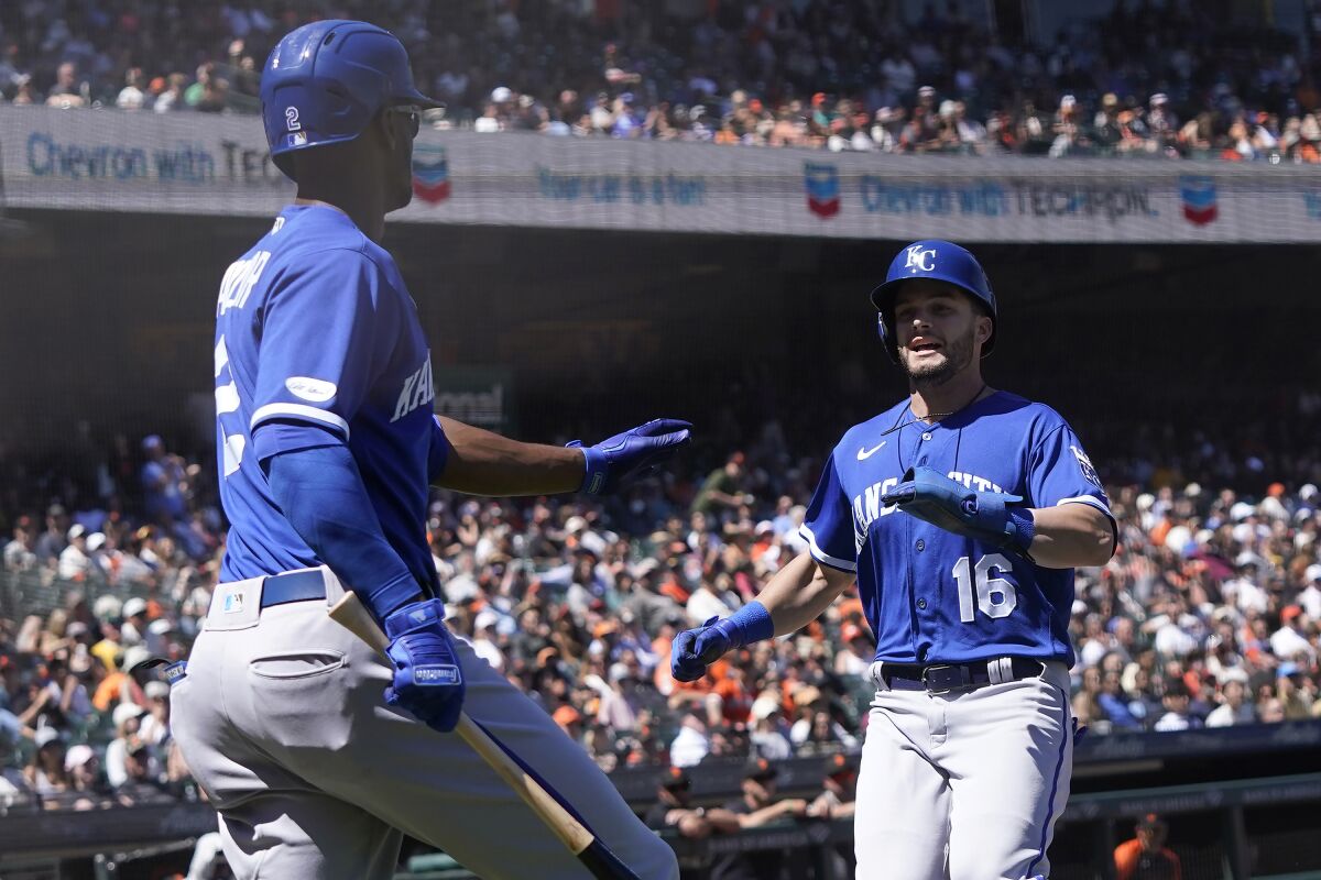 Kansas City Royals' Andrew Benintendi, right, is congratulated by Michael A. Taylor after scoring against the San Francisco Giants during the eighth inning of a baseball game in San Francisco, Wednesday, June 15, 2022. (AP Photo/Jeff Chiu)
