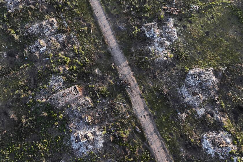 Houses and armoured vehicle destroyed during the fighting between Russian and Ukrainian armed forces are seen in recently liberated Klishchiivka, Donetsk region, Ukraine, Sunday, Sept. 24, 2023. (AP Photo/Alex Babenko).