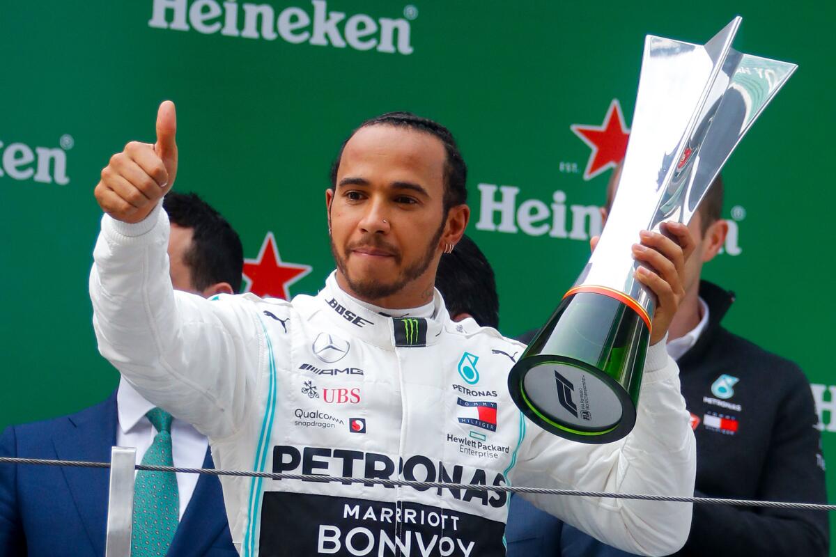 Formula One driver Lewis Hamilton hoists the winner's trophy at the Chinese Grand Prix last year.