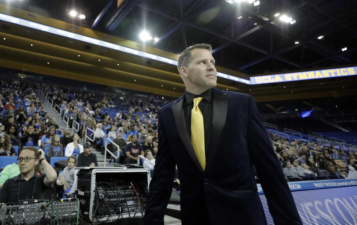 Chris Waller watches from the sideline during a UCLA gymnastics meet.