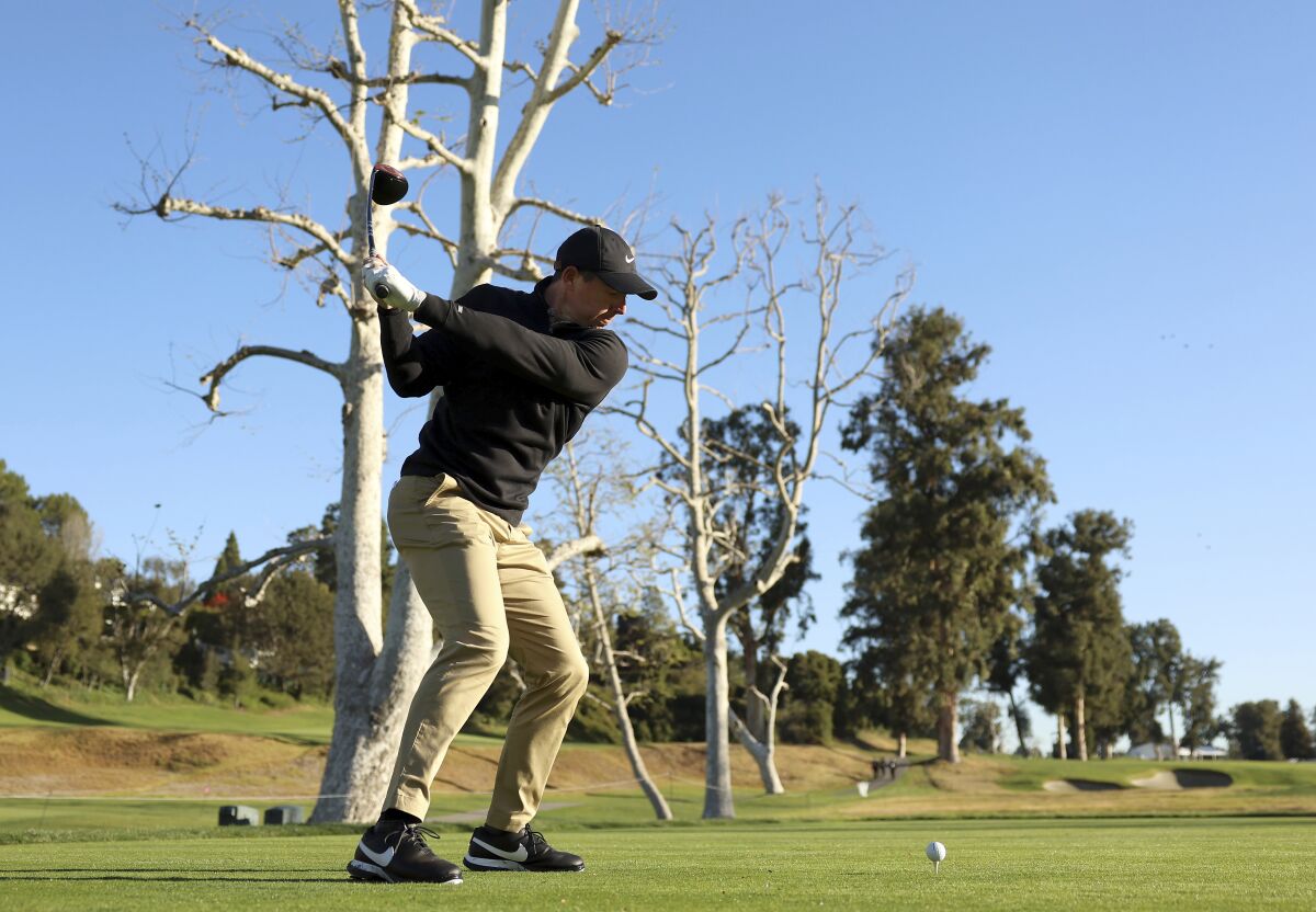 Rory McIlroy, of Northern Ireland, tees off on the 17th hole during the Genesis Invitational pro-am golf event at Riviera Country Club, Wednesday, Feb. 16, 2022, in the Pacific Palisades area of Los Angeles. (AP Photo/Ryan Kang)
