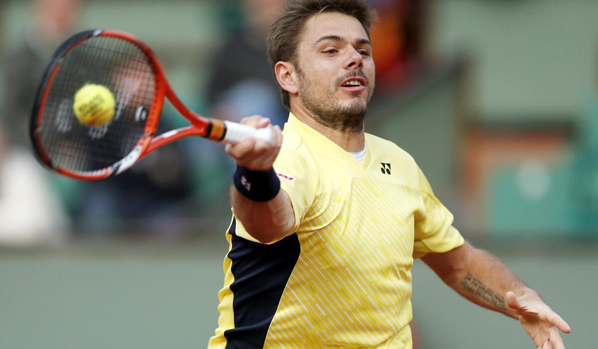 Stan Wawrinka reaches for a forehand return against Guillermo Garcia-Lopez in a first-round match at the French Open on Monday.