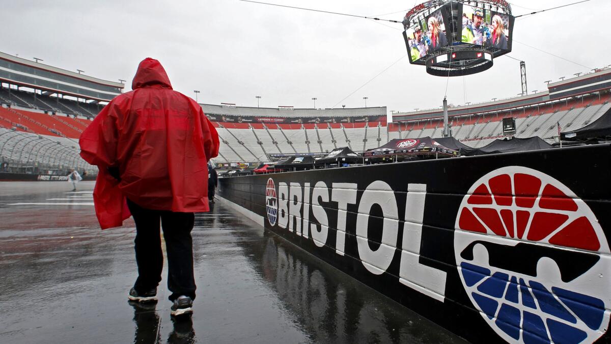A fan walks along the wall Sunday at Bristol Motor Speedway, where the Monster Energy NASCAR Cup Series race was postponed because of rain.