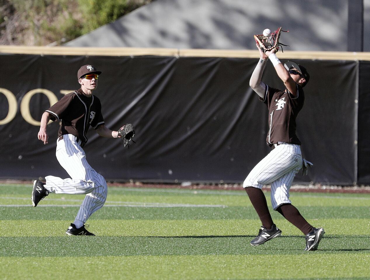 St. Francis' Jack Clougherty makes a game winning catch in center field as he and teammate Luke Crawshaw converge on the high fly ball hit by Alemany in a Mission League baseball game at the Glendale Sports Complex in Glendale on Monday, April 15, 2019. St. Francis won the game 6-4.