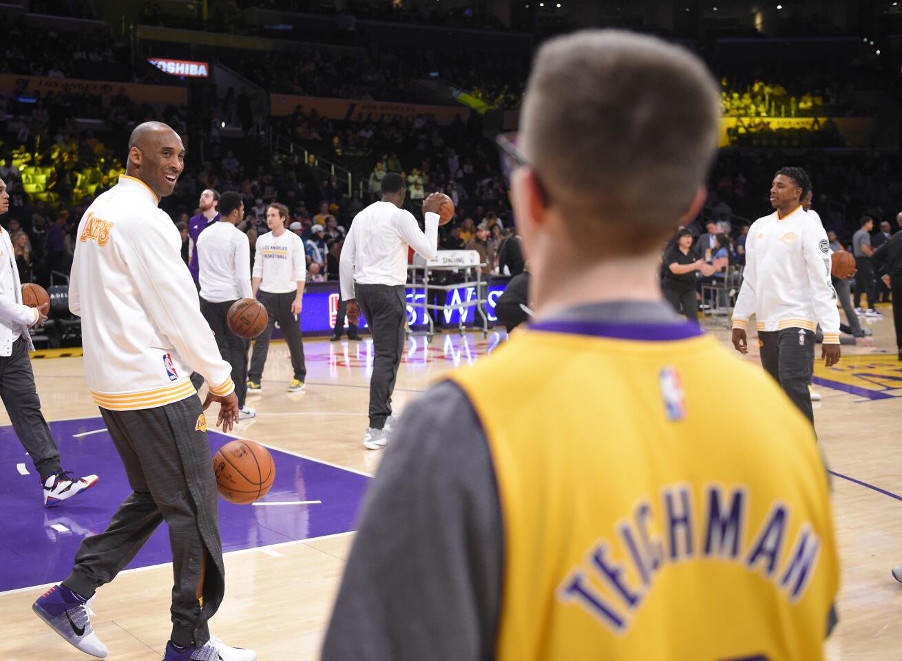 Los Angeles Lakers forward Kobe Bryant, left, talks with Make-A-Wish recipient, Yitzi Tiechman prior to an NBA basketball game against the Charlotte Hornets, Sunday, Jan. 31, 2016, in Los Angeles. The Lakers signed Teichman to a one day contract with the Lakers prior to the game. (AP Photo/Mark J. Terrill)