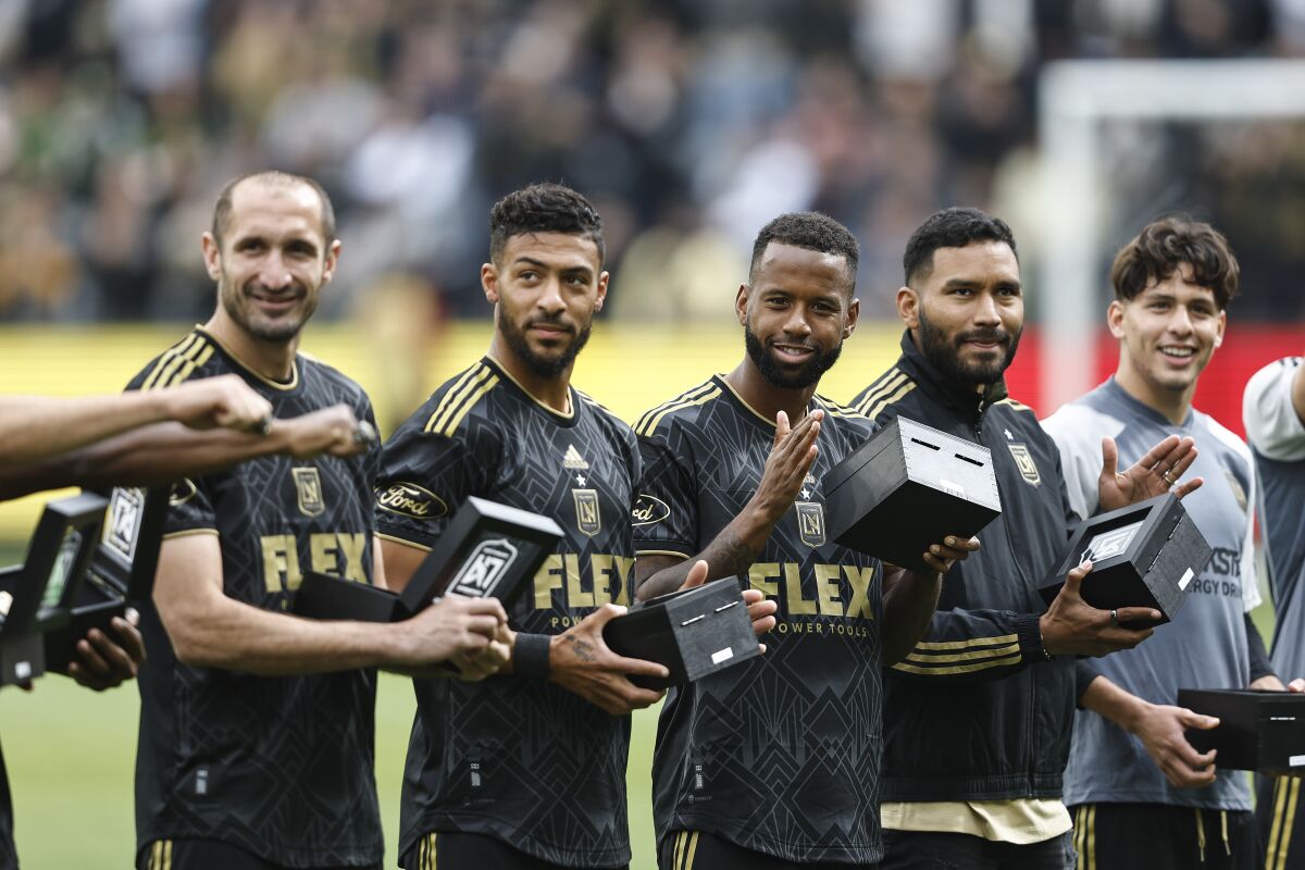 LAFC players accept their MLS Cup championship rings before the team's 3-2 season-opening win.