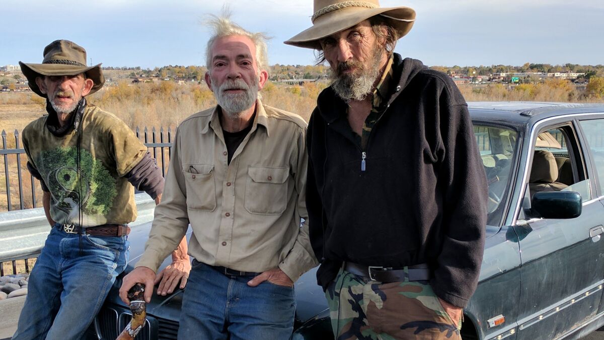 Larry Carlisle, center, set off from Oklahoma City for a new life in Pueblo, Colorado. The 58-year-old Carlisle camps out with friends who go by the names Cactus, left, and Cowboy.