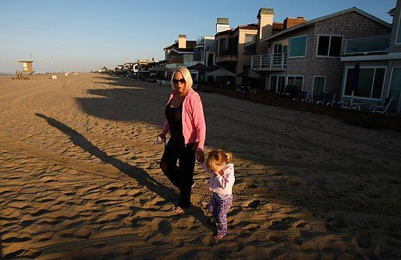 Linda Biehl takes an early-morning walk along the shore in Newport Beach with her 2-year-old granddaughter. Biehl's late husband, Peter, said of their work in South Africa: "We come to South Africa as Amy came, in a spirit of committed friendship. And make no mistake about it, extending a hand of friendship in a society which has been systematically polarized for decades is hard work at times.