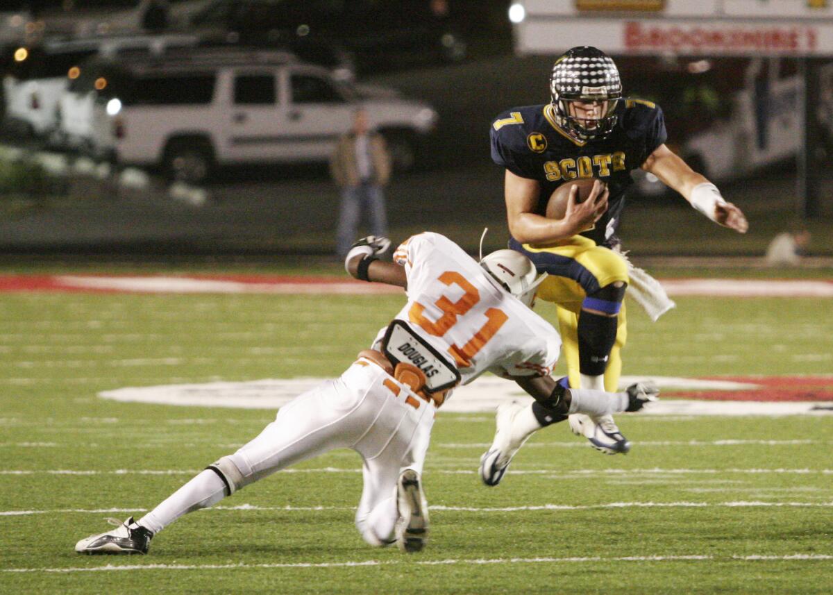 Highland Park quarterback Matthew Stafford leaps over a Texas High player 