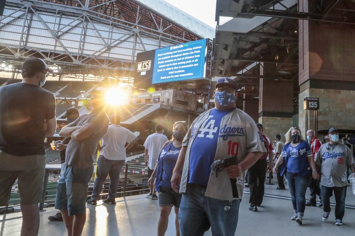Dodgers fans walk along the top of the left field pavilion at Globe Life Field in Arlington, Texas.