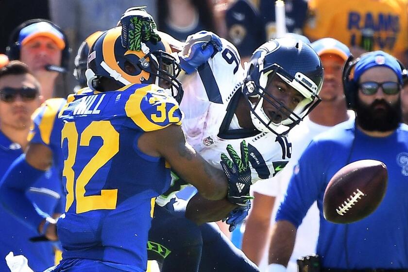 Rams cornerback Troy Hill is called for pass interference as he defends against Seahawks receiver Tyler Lockett in the second quarter Sunday.