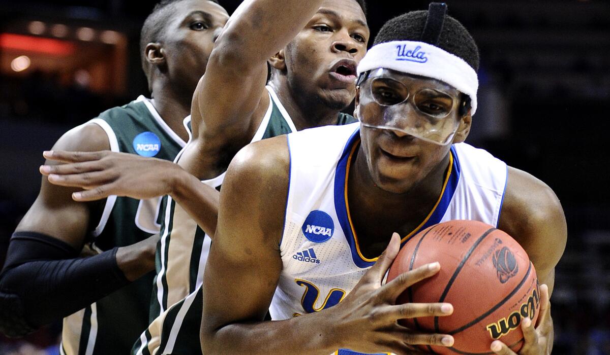 UCLA forward Kevon Looney grabs a rebound in front of UAB's Tosin Mehinti, left, and William Lee during the Bruins' 92-75 victory.