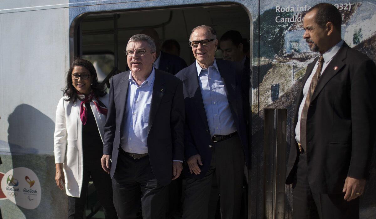 IOC President Thomas Bach, second from left, Olympic organizing committee president Carlos Arthur Nuzman, right, and head of the IOC's coordination commission Nawal El Moutawakel visit Rio de Janeiro on June 15.