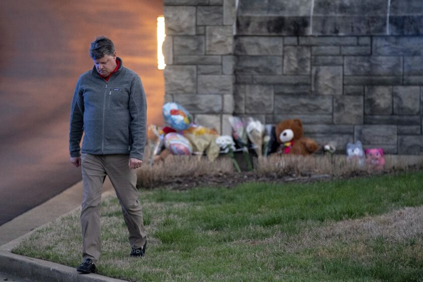 Curtis McDowell, who lives near Covenant School, walks away after placing flowers outside of the school's entrance in Nashville, Tenn., Monday, March 27, 2023. Multiple children and adults were killed during the school shooting. (Andrew Nelles/The Tennessean via AP)