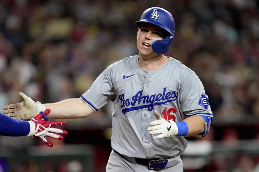 Los Angeles Dodgers' Will Smith crosses the plate after hitting a solo home run.