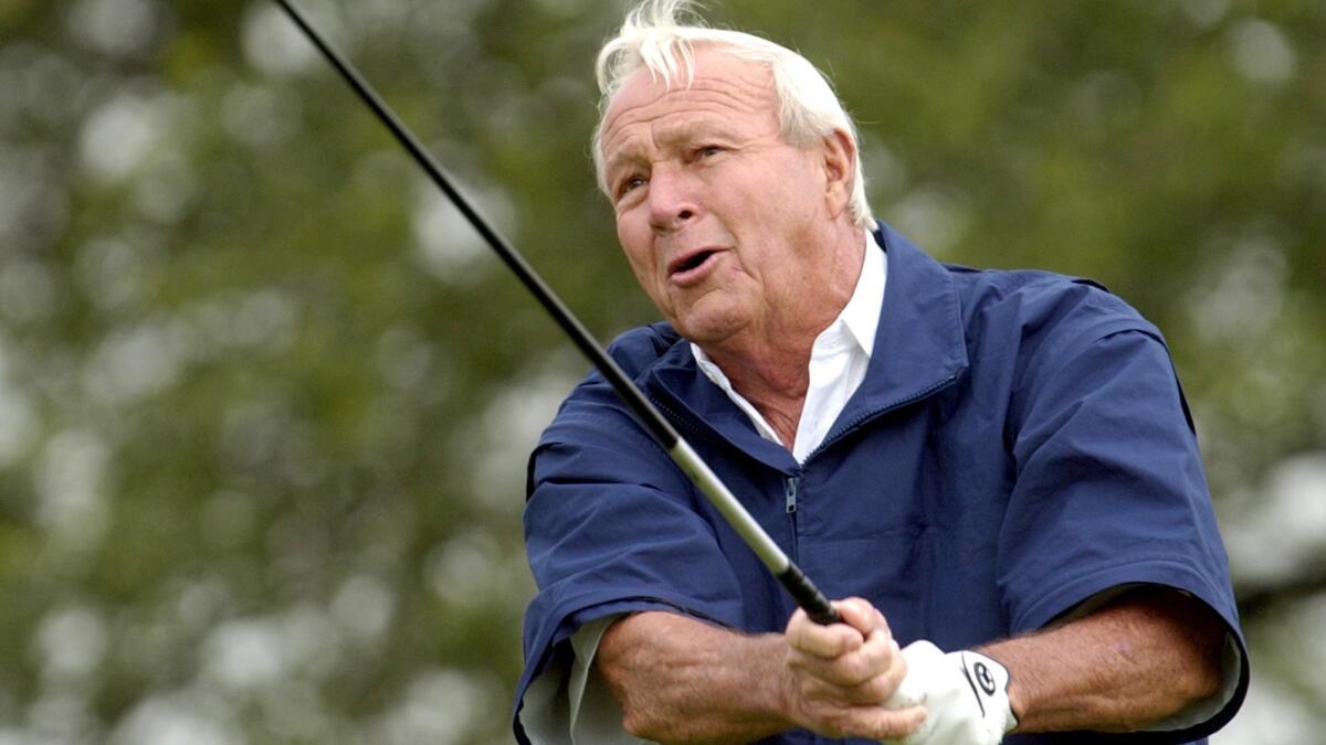 Arnold Palmer tees off during the Senior PGA Championship at Valhalla Golf Club in 2004.