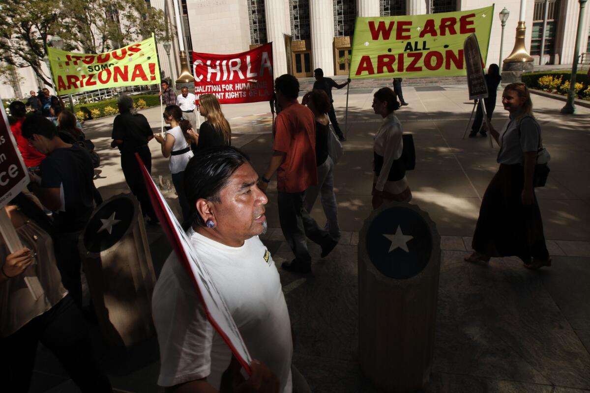 Alex Melendez marches with Immigration rights supporters and members of the Coalition for Humane Immigrant Rights of Los Angeles during a rally in response to the U.S. Supreme Court ruling on Arizona's immigration law, SB 1070, outside the Federal Court Building in downtown Los Angeles last summer.