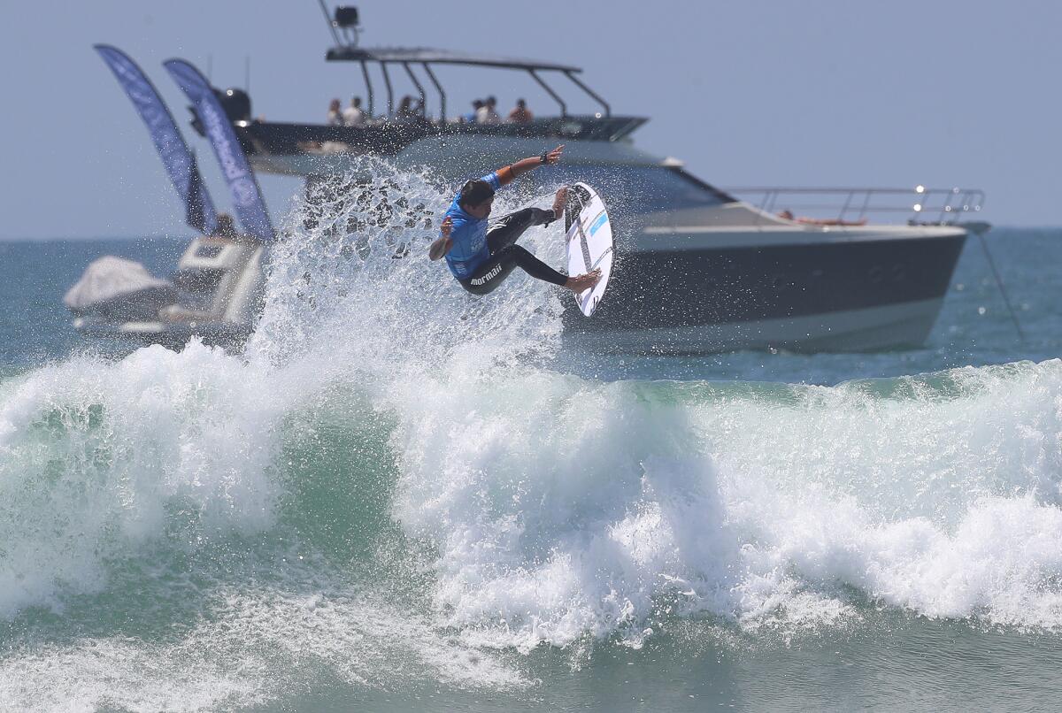 Miguel Pupo of Brazil completes a high air reverse in the U.S. Open of Surfing at the Huntington Beach Pier.