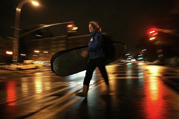 Mary Setterholm walks from her dorm at Union Theological Seminary to the subway in Harlem about 5:45 am, on her way to the beach.