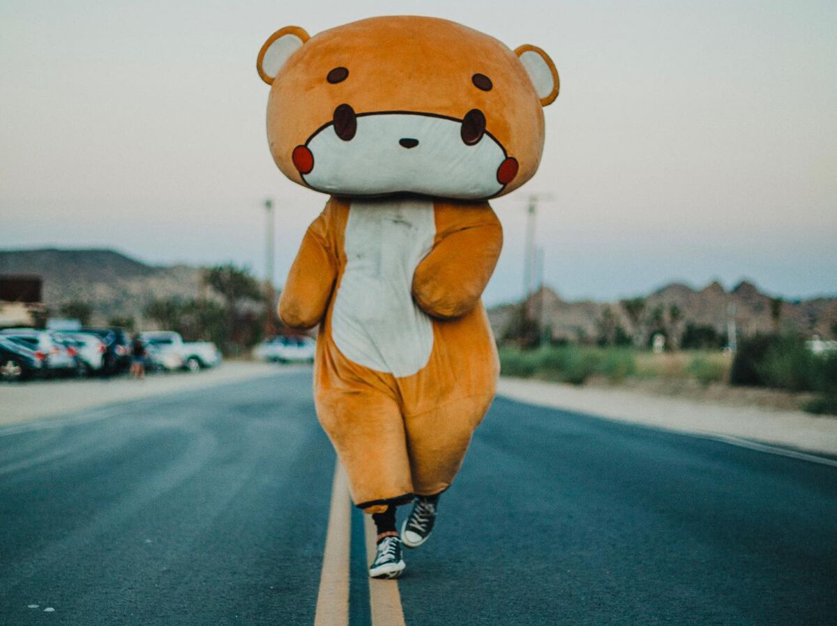 Jessy Larios, 33, of Lynwood, walks for charity in his Bearsun cartoon character costume.  