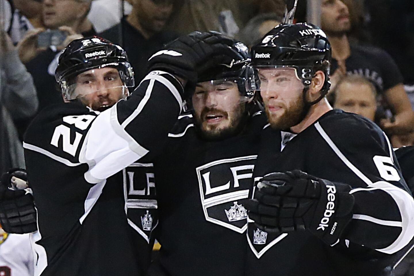 Kings defenseman Drew Doughty, center, is congratulated by teammates Jarret Stoll, left, and Jake Muzzin after scoring in the third period of the Kings' 4-3 win over the Chicago Blackhawks in Game 3 of the Western Conference finals at Staples Center.