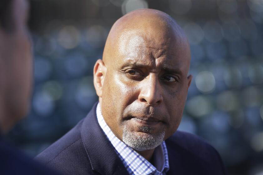 FILE - In this March 17, 2015, file photo, Tony Clark, executive director of the baseball players' union, talks to reporters before a spring training baseball game between the Detroit Tigers and the Washington Nationals in Lakeland, Fla. Players who test positive for opioids would enter treatment and not be suspended under the change to Major League Baseball's drug agreement being negotiated by management and the players' association, according to union head Tony Clark. (AP Photo/Carlos Osorio, File)
