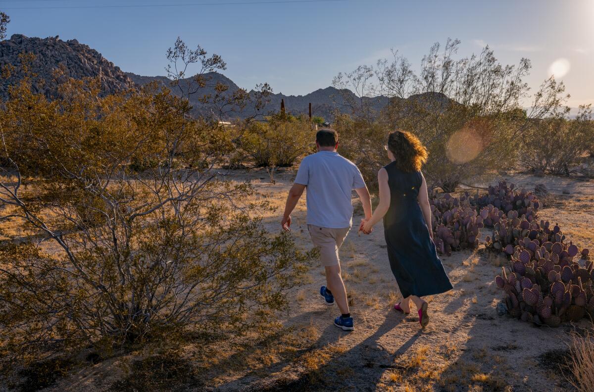 Colin Campbell and his wife Gail take a stroll in the desert landscape.