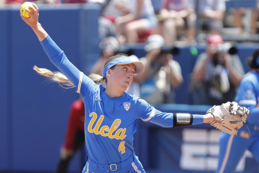 UCLA's Holly Azevedo (4) pitches in the seventh inning of an NCAA softball Women's College World Series.