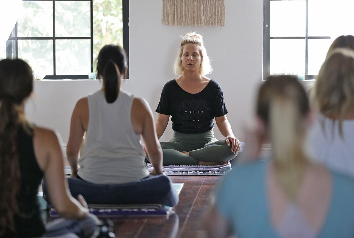 Instructor Alison Zimmer begins a breathing exercise in her Zen Den during a class in Huntington Beach.