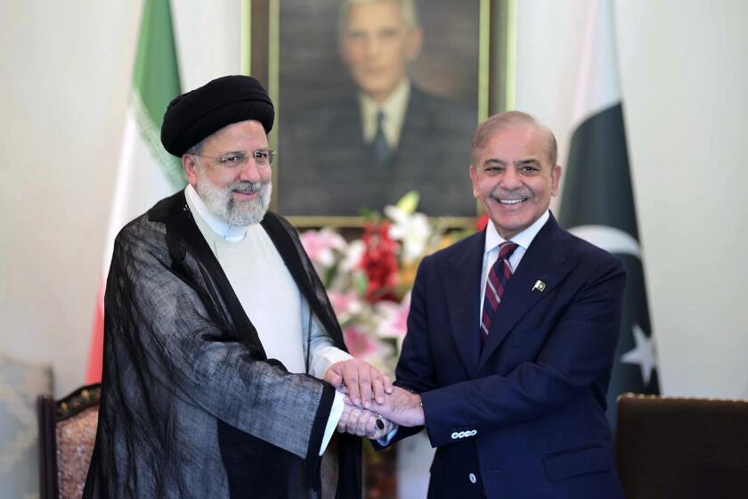 In this photo released by Press Information Department, Iranian President Ebrahim Raisi, left, shakes hand with Pakistan's Prime Minister Shehbaz Sharif prior to their meeting at prime minister house in Islamabad, Pakistan, Monday, April 22, 2024. Iranian and Pakistani leaders vowed to strengthen economic and security cooperation in a meeting on Monday, as the two countries seek to smooth over a diplomatic rift. (Press Information Department via AP)