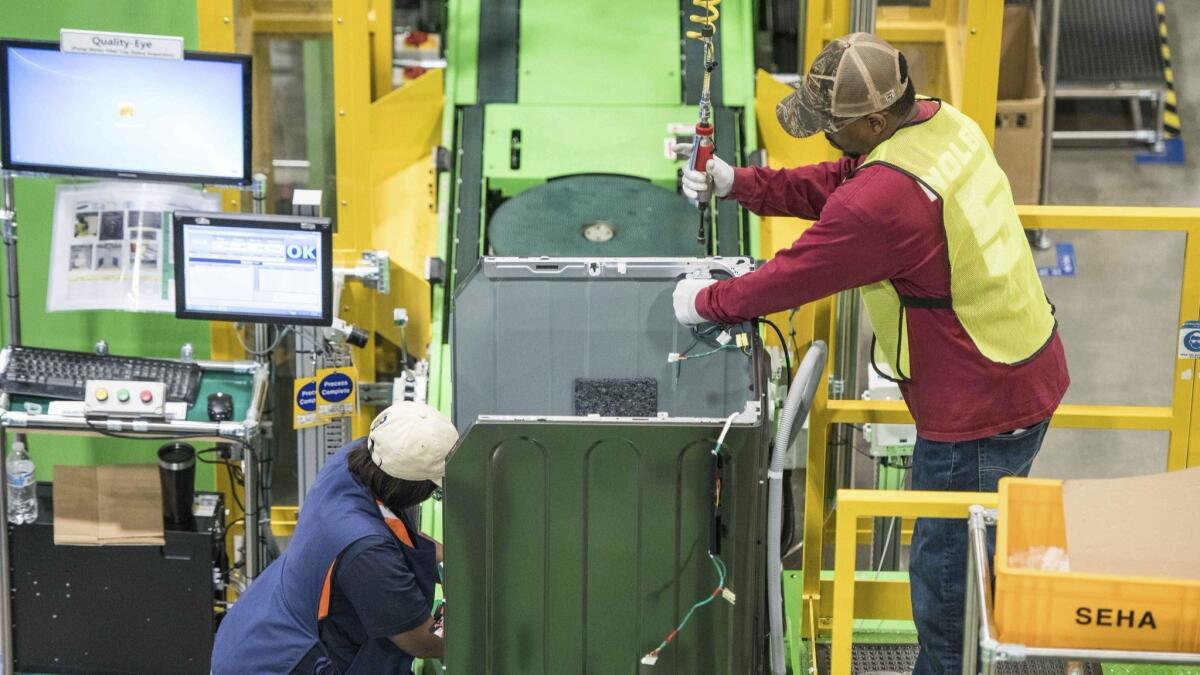 Workers build washing machines on the assembly line at a Samsung facility in South Carolina. U.S. manufacturing jobs increased in March.