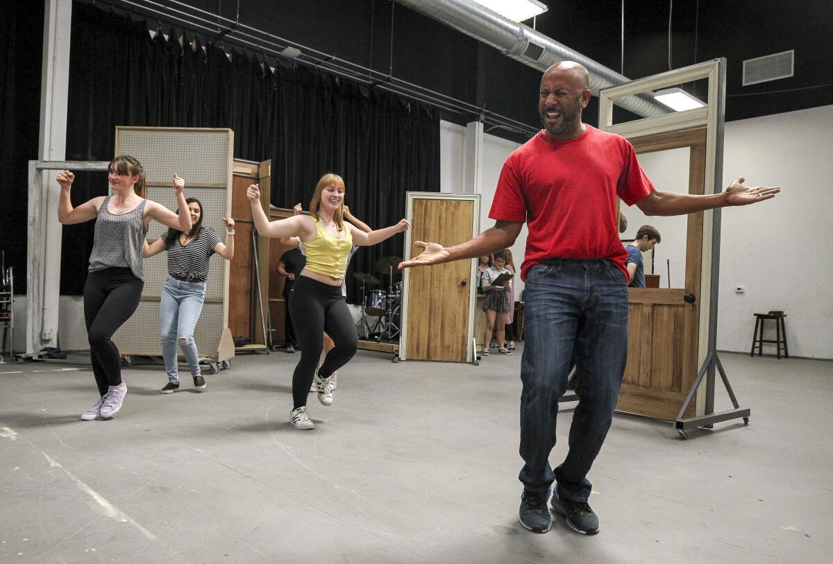 Actor Ron Jones (right) performs with cast mates during a rehearsal for "33 1/3: House of Dreams" at the Rep's rehearsal space.
