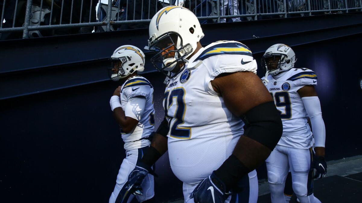 Chargers defensive lineman Brandon Mebane takes the field with teammates before a playoff game against the Patriots in January.