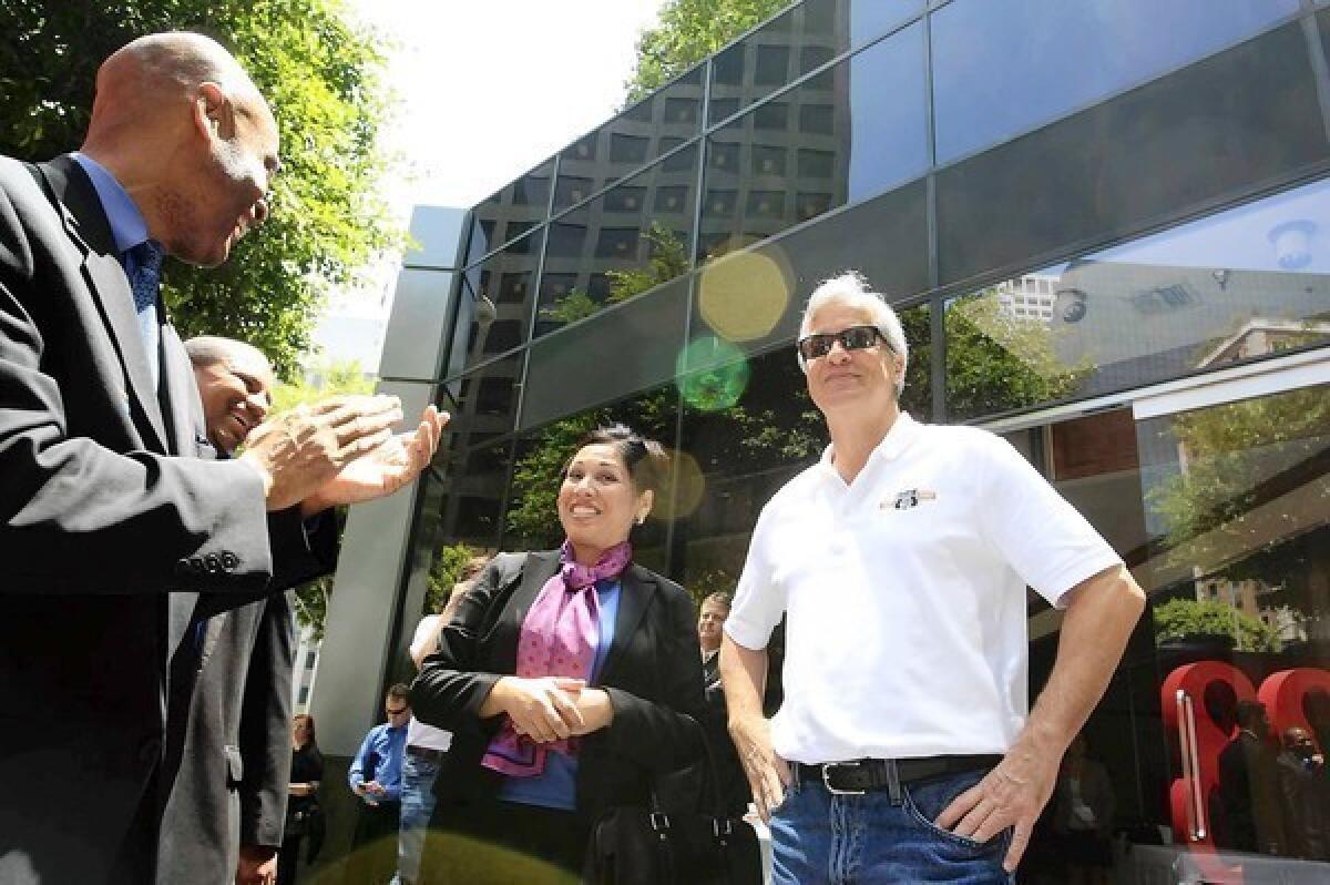 JPMorgan Chase Chairman Jamie Dimon, right, greets employees at a new branch at 888 W. 6th St. [For the Record: An earlier version of this caption spelled his name "Damon."]
