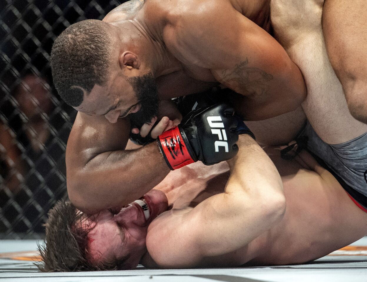 Tyron Woodley, top, elbows Darren Till in the face during their welterweight title mixed martial arts bout at UFC 228 on Saturday, Sept. 8, 2018, in Dallas. Woodley won by submission. (AP Photo/Jeffrey McWhorter)