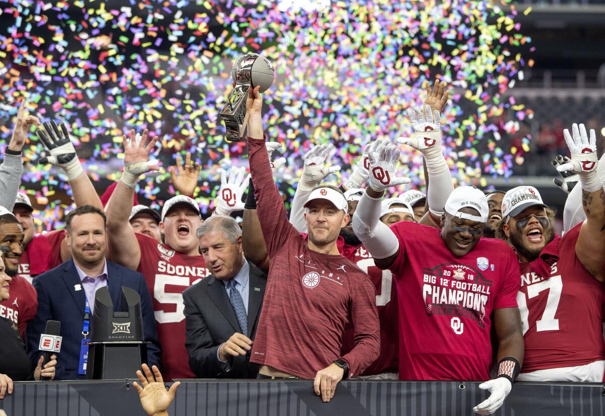 Oklahoma coach Lincoln Riley hoists the Big 12 championship trophy after the Sooners beat Baylor 30-23 on Dec. 7, 2019.