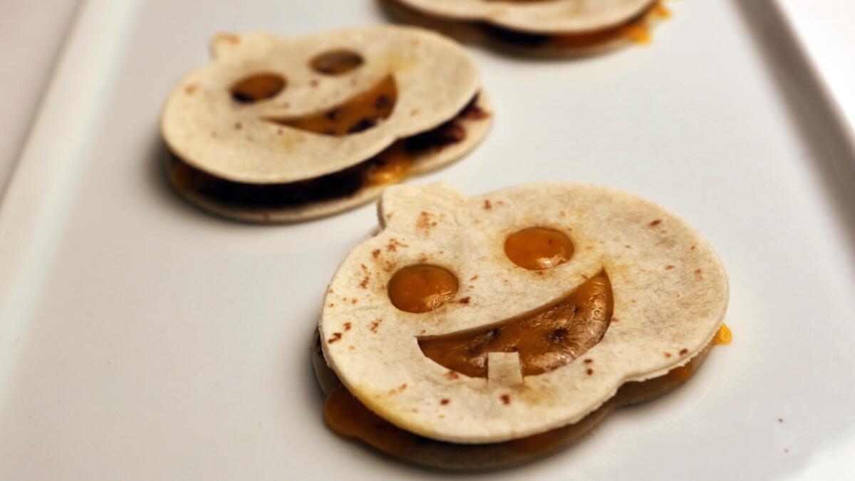 Quesadillas shaped to look like jack o'lanterns on a tray