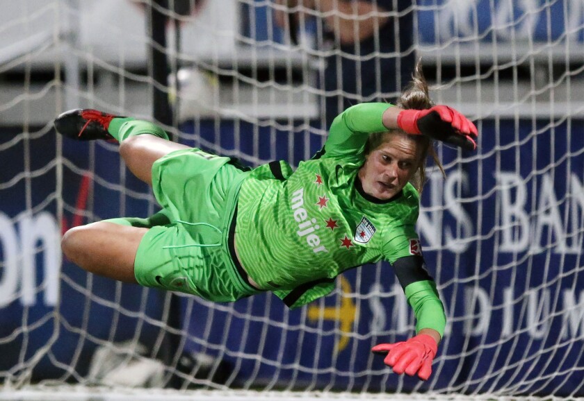 FILE - Chicago Red Stars goalkeeper Alyssa Naeher dives for the ball during a win in penalty kicks against the OL Reign in an NWSL Challenge Cup soccer match at Zions Bank Stadium, July 18, 2020, in Herriman, Utah. After a heartbreaking exit from the Tokyo Olympics, Naeher is back with the U.S. women's national team. (AP Photo/Rick Bowmer, File)